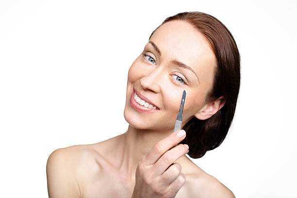 Smiling woman applying eye cream